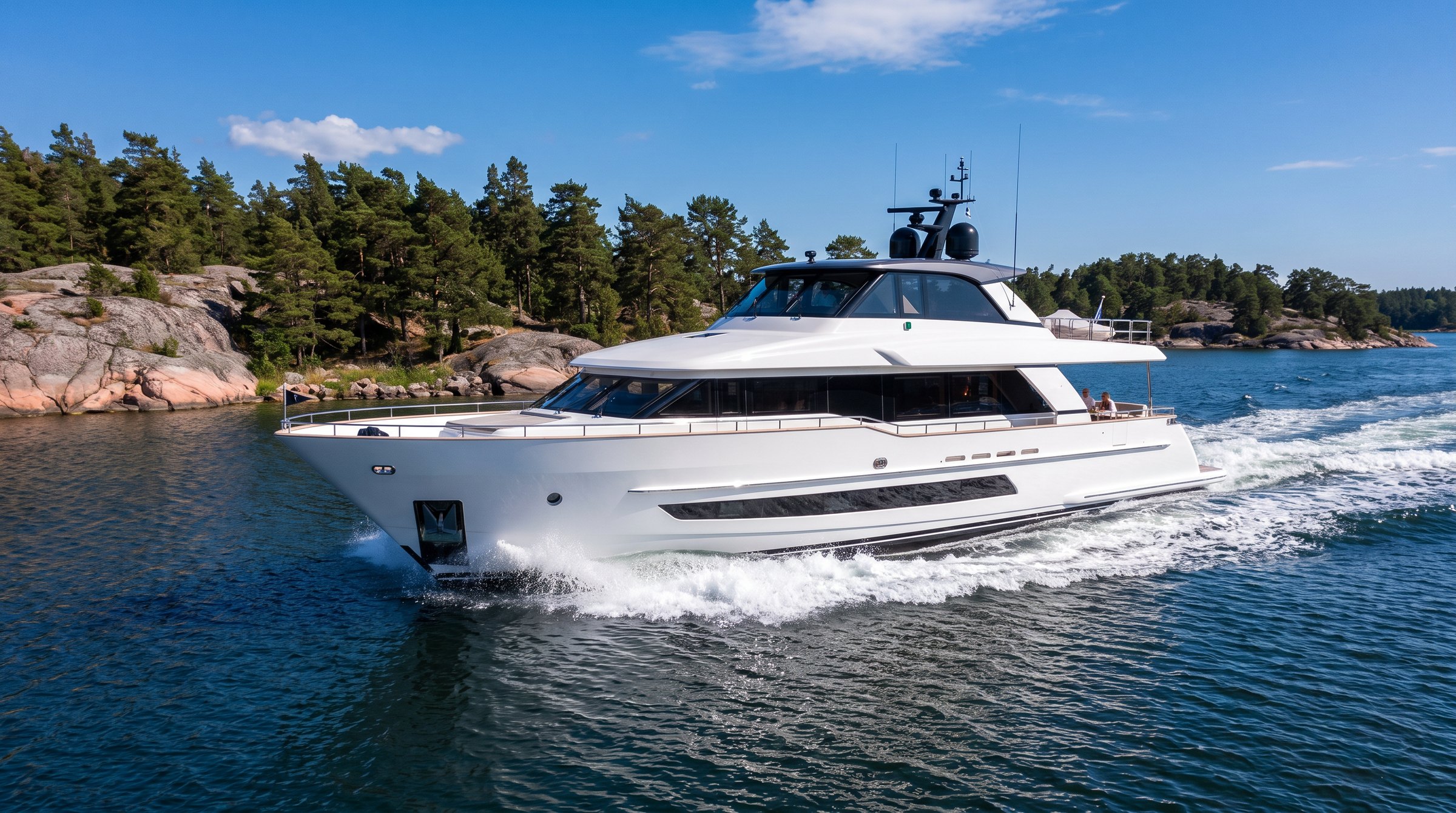 Vit motoryacht i fart mellan skärgårdsöar en solig sommardag